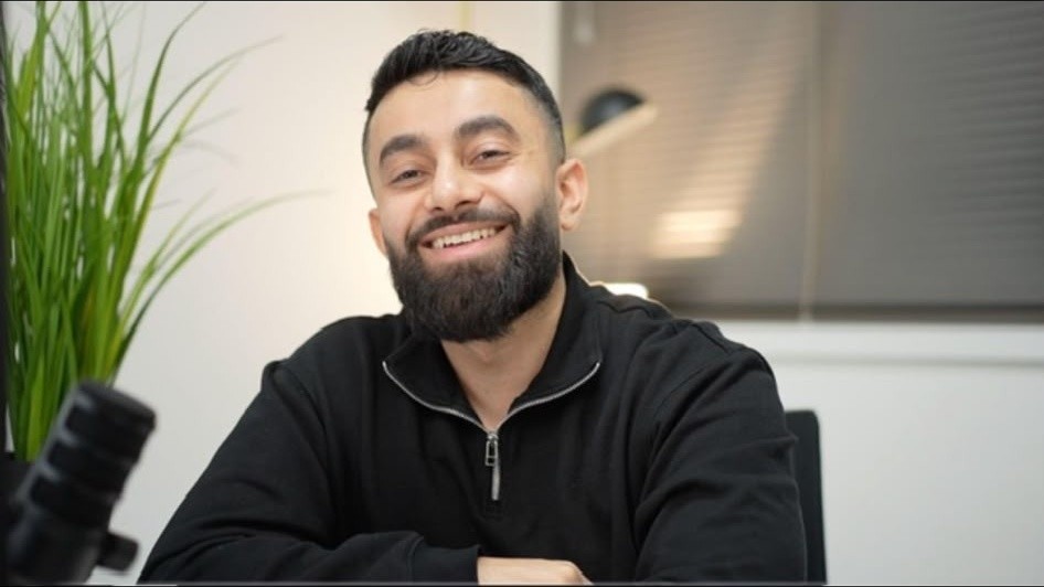 Abu Musa smiling in his office