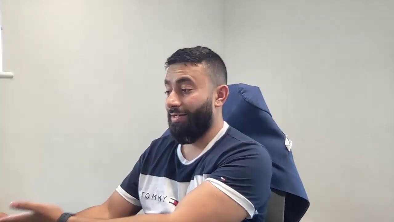 Abu Musa talking at a desk